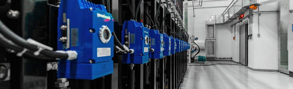 Close-up panoramic photo of stainless steel pipes in the factory. Chemistry and medicine production. Pharmaceutical high-tech plant interior and modern production.