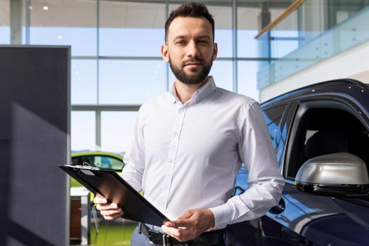 manager in a car dealership prepares papers for buying a new car.