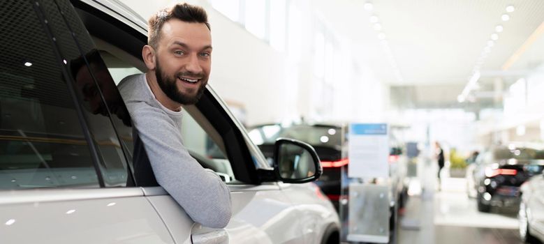 a satisfied customer purchases a new car at a dealership.