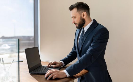 businessman man working on a laptop in a stylish suit.