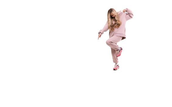 girl in a pink sports suit jumping on a white background.