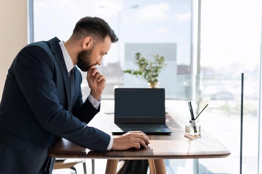 office worker looking at laptop screen.
