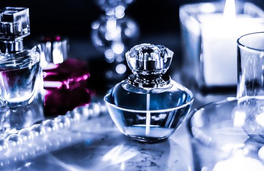 Perfumery, cosmetics branding and luxe concept - Perfume bottle and vintage fragrance on glamour vanity table at night, pearls jewellery and eau de parfum as holiday gift, luxury beauty brand present