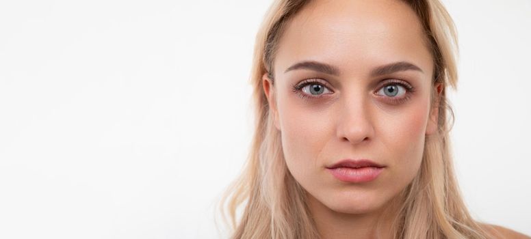 close-up portrait of a beautiful young woman with well-groomed facial skin.