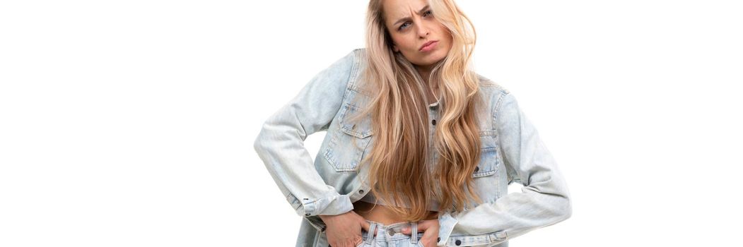 stylish young woman in denim suit fooling around on background without looking at camera.