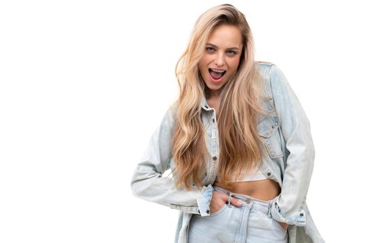 cheerful blonde on a white background with open mouth smiles and looks at the camera.