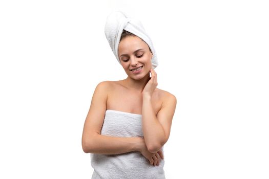 sexy middle-aged woman after spa treatments with well-groomed skin on a white background.