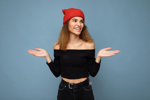 Photo of young positive happy smiling beautiful woman with sincere emotions wearing stylish clothes isolated over background with copy space.
