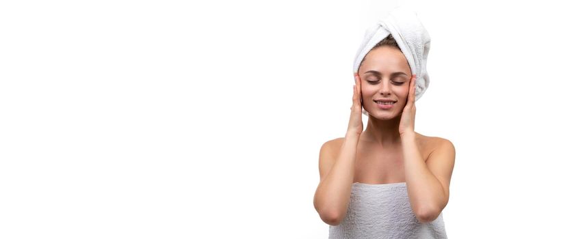 young satisfied woman after spa treatments touches her face with her hands, Concept skin rejuvenation.