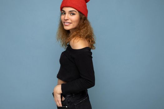 Beautiful young brunette woman isolated over blue background wall wearing casual stylish clothes feeling sincere emotions looking at camera. Free space