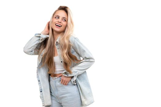 blonde woman on white background posing with a smile.