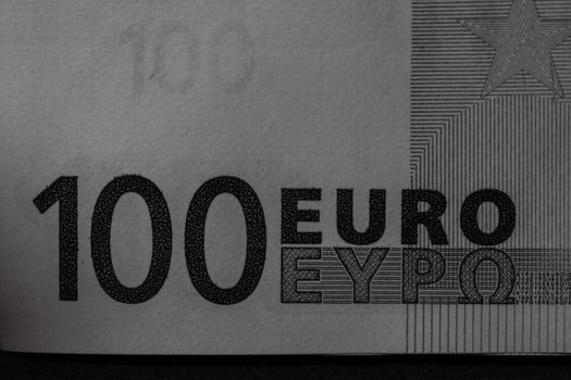 Selective focus on detail of euro banknotes. Close up macro detail of money banknotes, 100 euro isolated. World money concept, inflation and economy concept