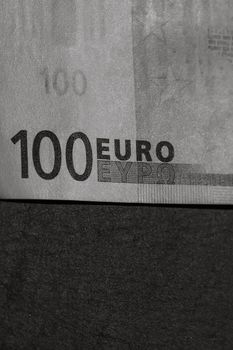 Selective focus on detail of euro banknotes. Close up macro detail of money banknotes, 100 euro isolated. World money concept, inflation and economy concept