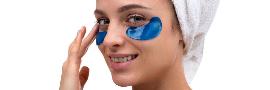 beautiful woman with blue patches on the face skin care around the eyes, cosmetic procedures.