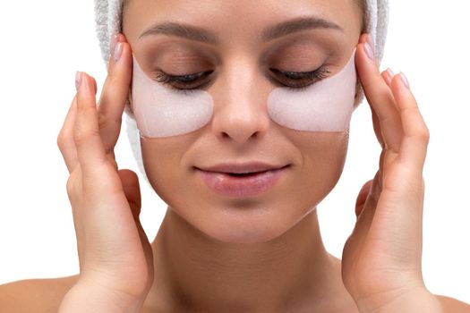 woman massages whiskey with patches on her face, spa concept.