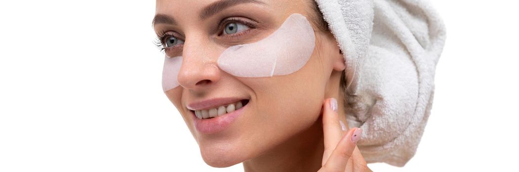 middle aged woman with cosmetic patches on her face, spa concept.