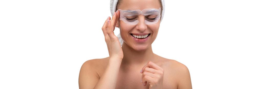 young woman takes care of the skin around the eyes, the concept of cosmetic procedures tour for female skin.