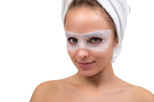 attractive woman on with with a fabric cosmetic mask for skin care around the eyes.