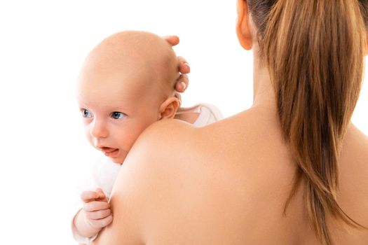 Curious newborn in mother's arms looks away, vaccinations and vaccinations of the baby.