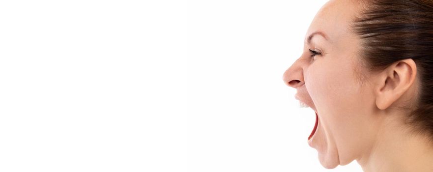 a woman emotionally screams with her mouth wide open, profile picture on a white background.