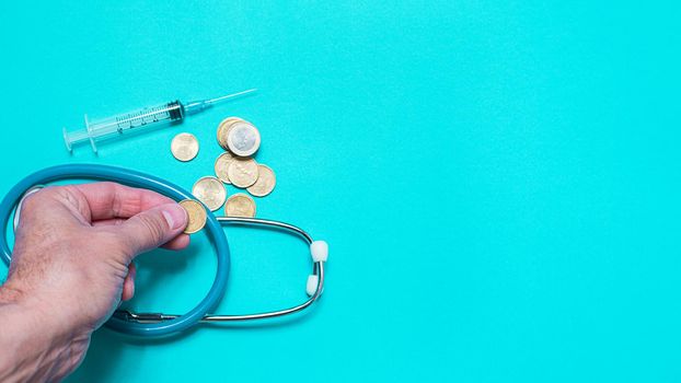 Concept of scientific research in medicine. Biotechnology banner with medical syringe stethoscope and money. Copyspace for text. flatlay.