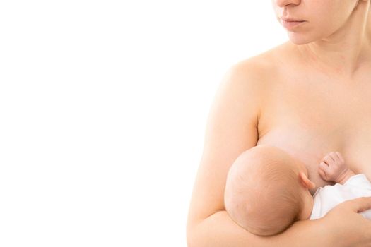 newborn baby takes mother's breast and drinks milk on a white background.