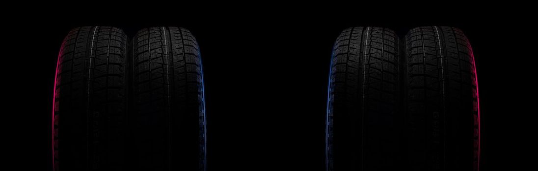 two black tires on a black background with a tread for driving on snow.