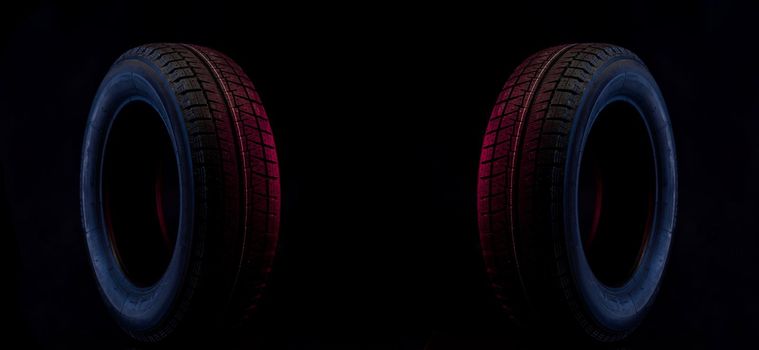 winter wheel for a car on a stylish black and blue red background.