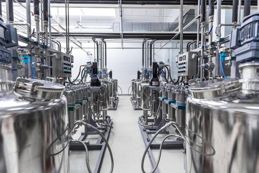 Photo of pipes and tanks. Chemistry and medicine production. Pharmaceutical factory. Interior of a high-tech plant, modern production.