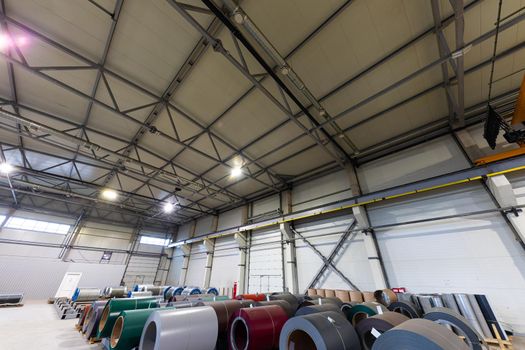 Photo shot of rolls of steel sheet stored in warehouse; Cold rolled steel coils at the factory.