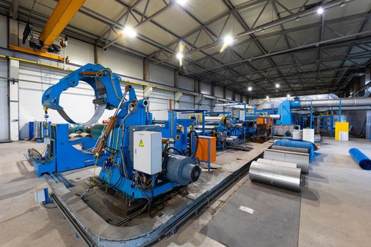 Photo shot of rolls of steel sheet stored in warehouse; Cold rolled steel coils at the factory.