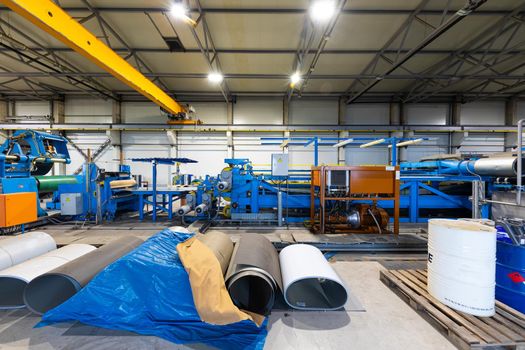 Photo shot of rolls of steel sheet stored in warehouse; Cold rolled steel coils at the factory. Engineering production.