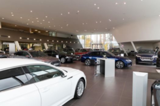 car dealership premium class, modern car dealer interior, photo with blur.