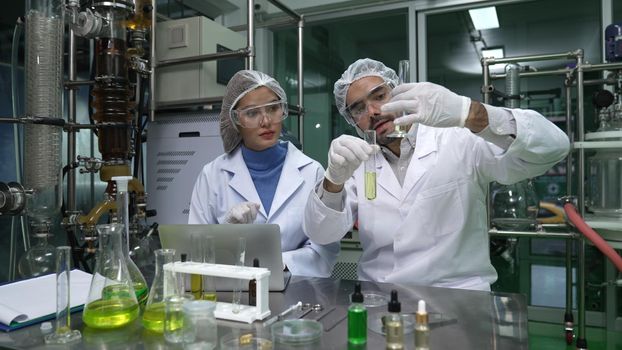 Two scientist in professional uniform working in laboratory for chemical and biomedical experiment