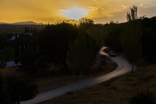 car driving on a road illuminated at dawn