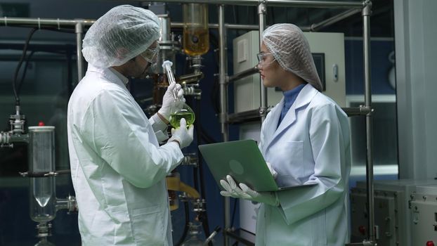 Two scientist in professional uniform working in laboratory for chemical and biomedical experiment