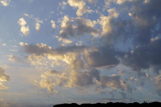 dramatic sky at sunrise with yellow colors with trees at the bottom