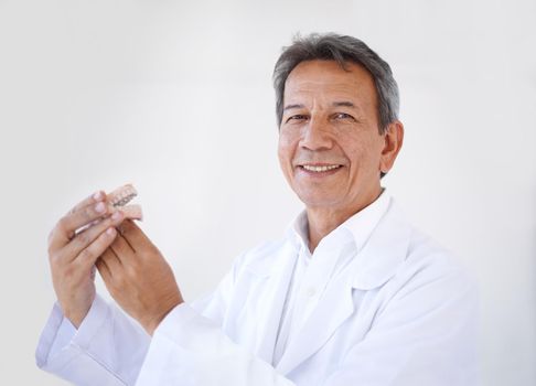 Hes the best surgeon around. Portrait of a mature male dental surgeon standing in his office