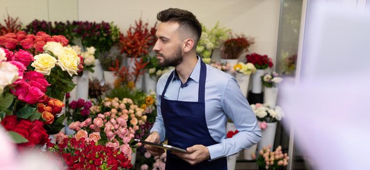 seller in the bouquet shop on the background of fresh flowers.