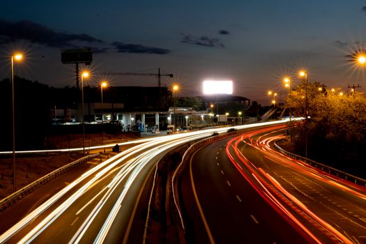 Madrid, Spain - Sep 24, 2022: Long exposure shot taken from a bridge that crosses the M-607 road in Montecarmelo looking towards Madrid. Hundreds of cars go to and from the city.