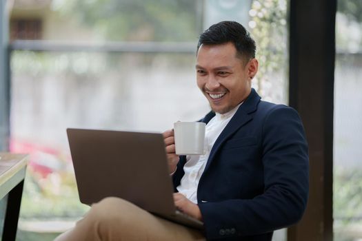 A successful entrepreneur analyzing a technical price graph and indicator with laptop computer.