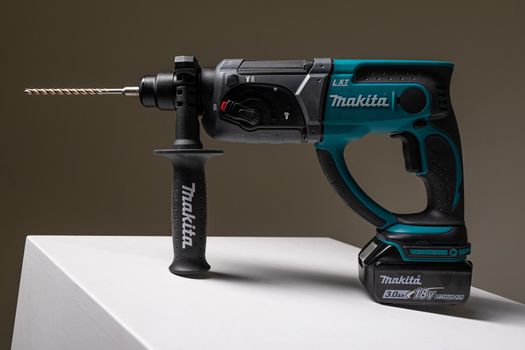 Photo of Makita drill instrument tool for drilling holes isolated on background with copy space. Repair and construction concept.