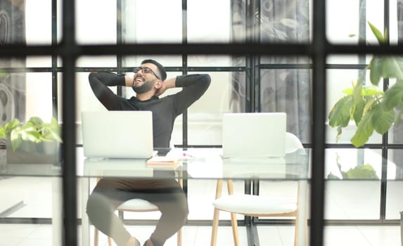 Businessman using his laptop, pc. Serious handsome bearded man worker laptop