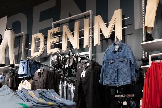shop interior during sale of stylish trendy denim clothing for youth.
