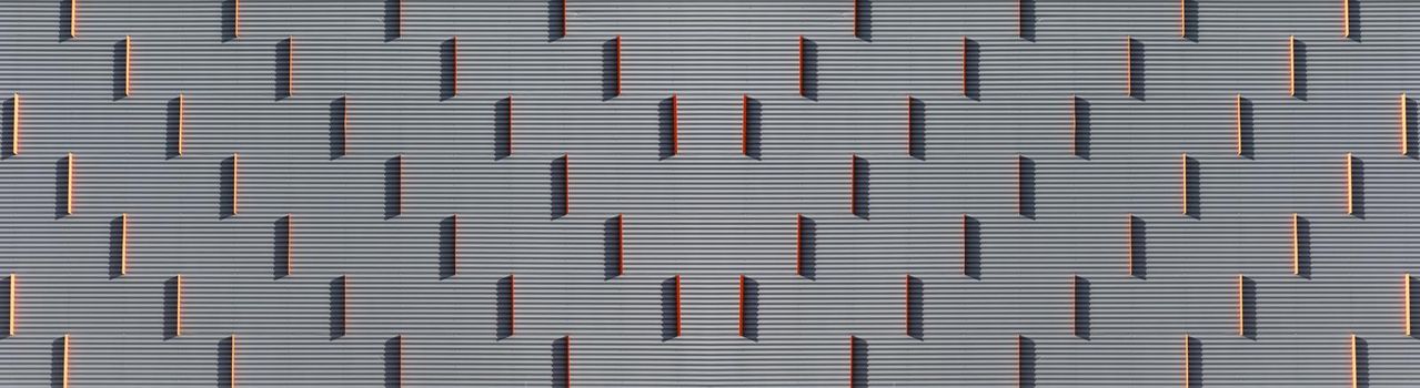 abstraction, orange vertical stripes on a gray embossed background.