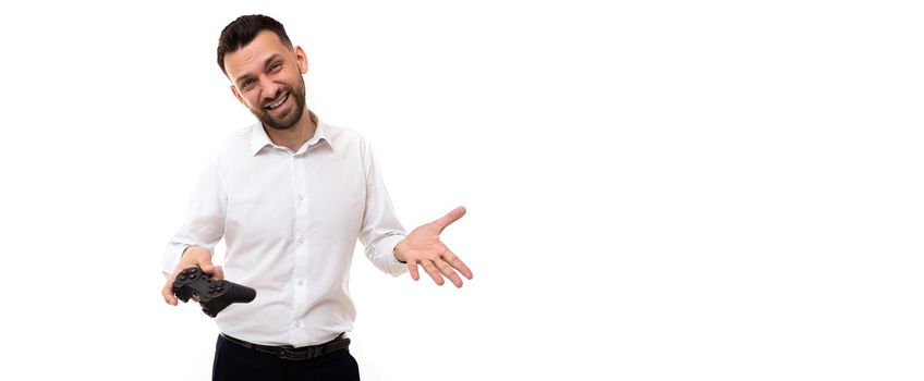 young man in a white shirt with a game joystick in his hands indignant expanding his hands gesturing.