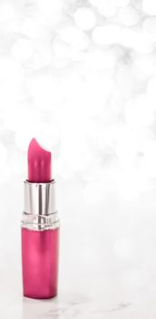 Cosmetic branding, sale and glamour concept - Pink lipstick on silver Christmas, New Years and Valentines Day holiday glitter background, make-up and cosmetics product for luxury beauty brand