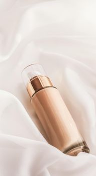 Cosmetic branding, glamour and skincare concept - Tonal bb cream bottle make-up fluid foundation base for nude skin color on silk background, cosmetics product as luxury beauty brand holiday design