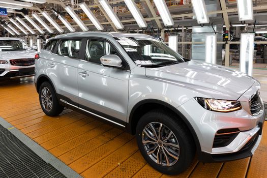 Photo of modern car assembly plant. Interior of a high-tech factory of new automobiles.