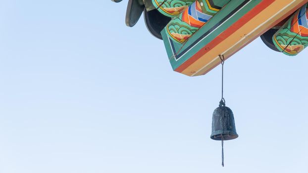 Bell on a painted roof with patterns, Buddhist temple, background. High quality photo
